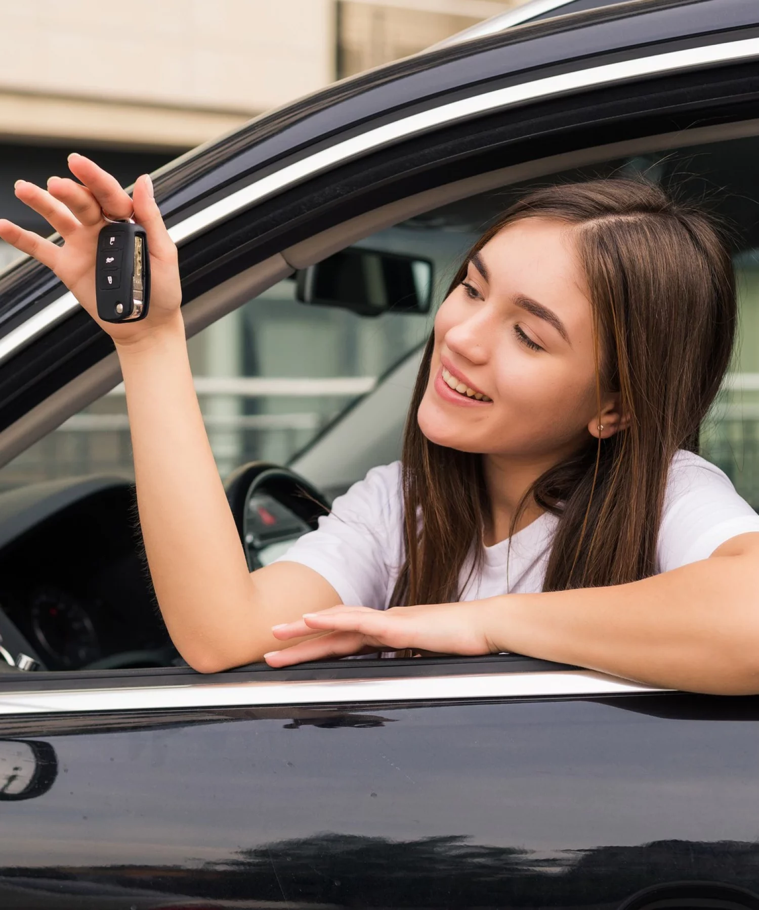 happy-young-smiling-woman-with-new-car-key_231208-11939